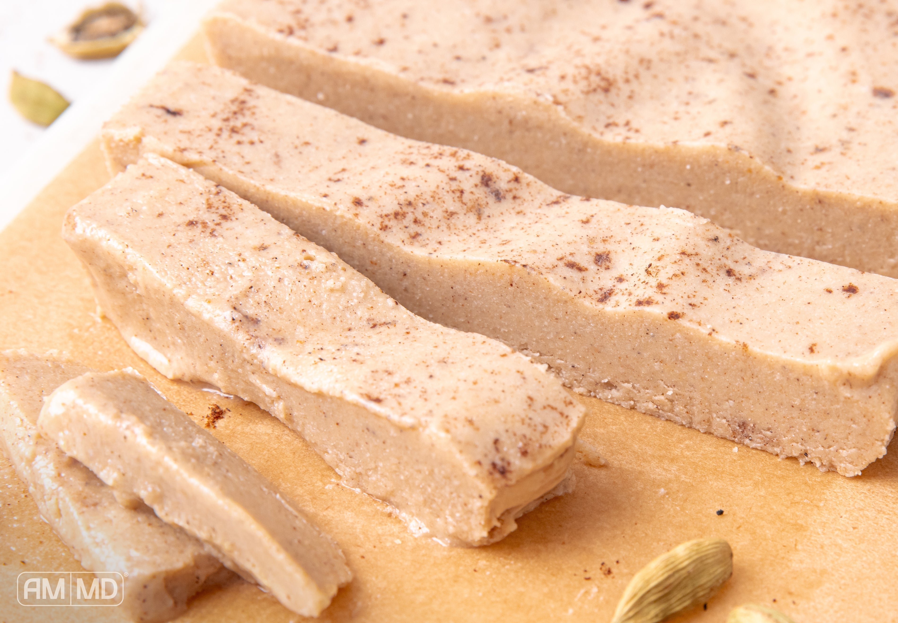 Creamy gluten and dairy-free vanilla chai halva slices dusted with cinnamon and speckled with chai spices.