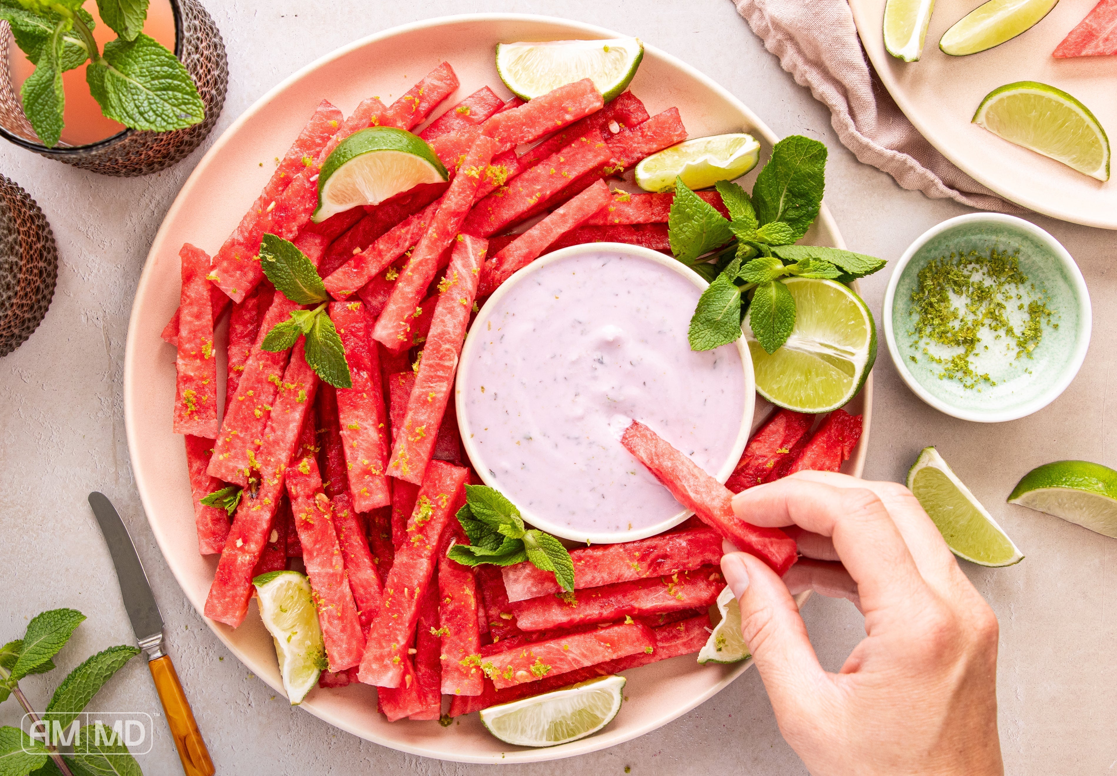Dipping a watermelon fry into the coconut lime dip -  Watermelon Fries - AMMD™
