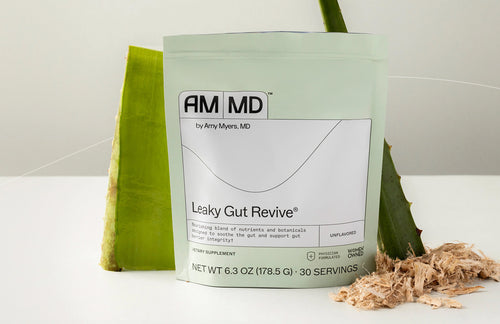 A pouch of Leaky Gut Revive by Amy Myers MD, surrounded by aloe leaves and marshmallow root on a clean, light background.